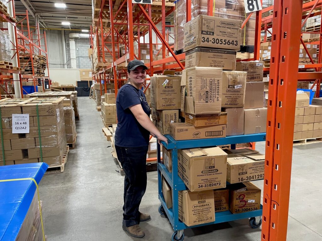 Worker moving a cart filled with boxes